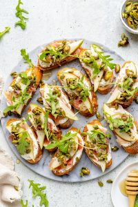 Ricotta and Pear Crostini with Salty Pumpkin Seed Pistachio Crunch