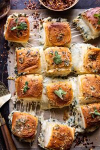 Pull Apart Garlic Butter Spinach and Artichoke Dip Sliders.